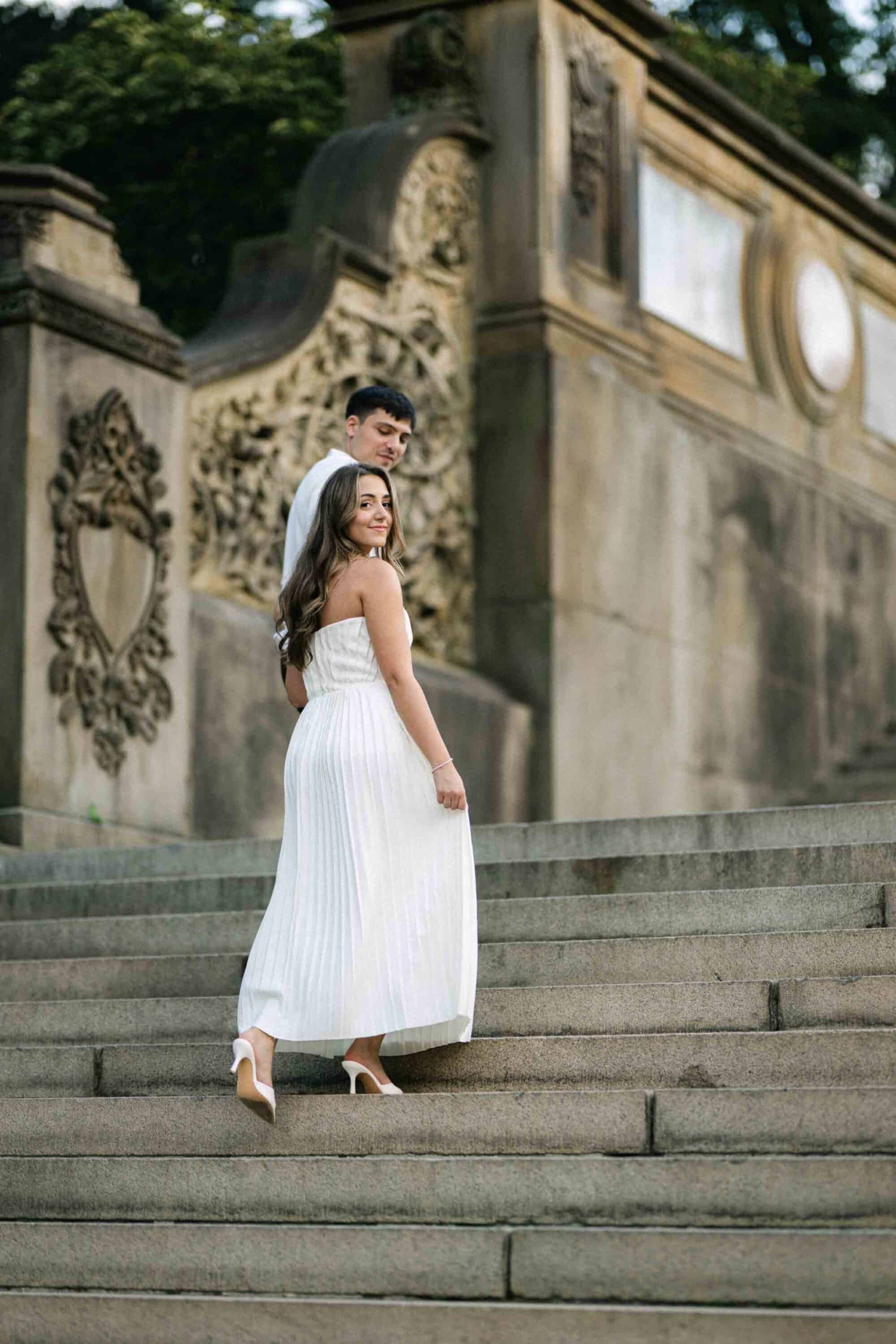 Candid Central Park engagement photos of a couple walking through the park