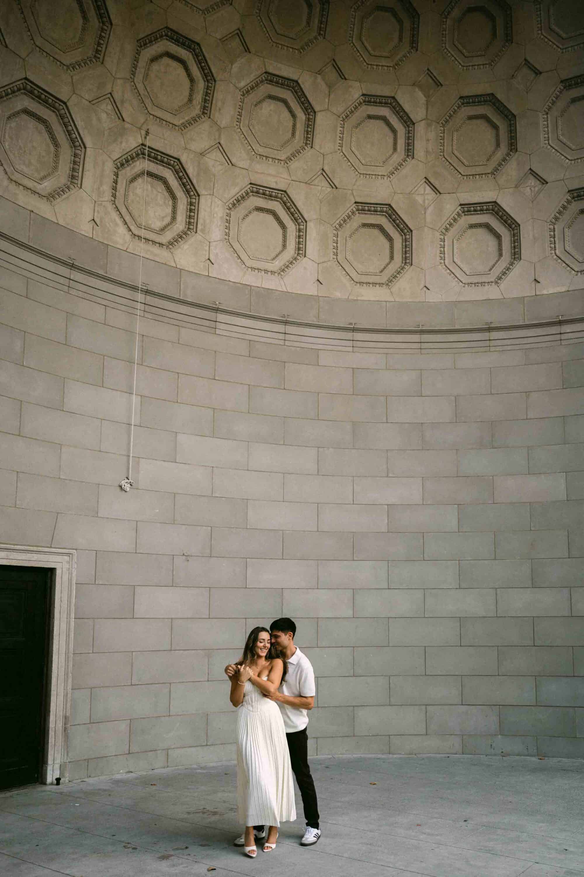 Candid Central Park engagement photos of a couple walking through the park