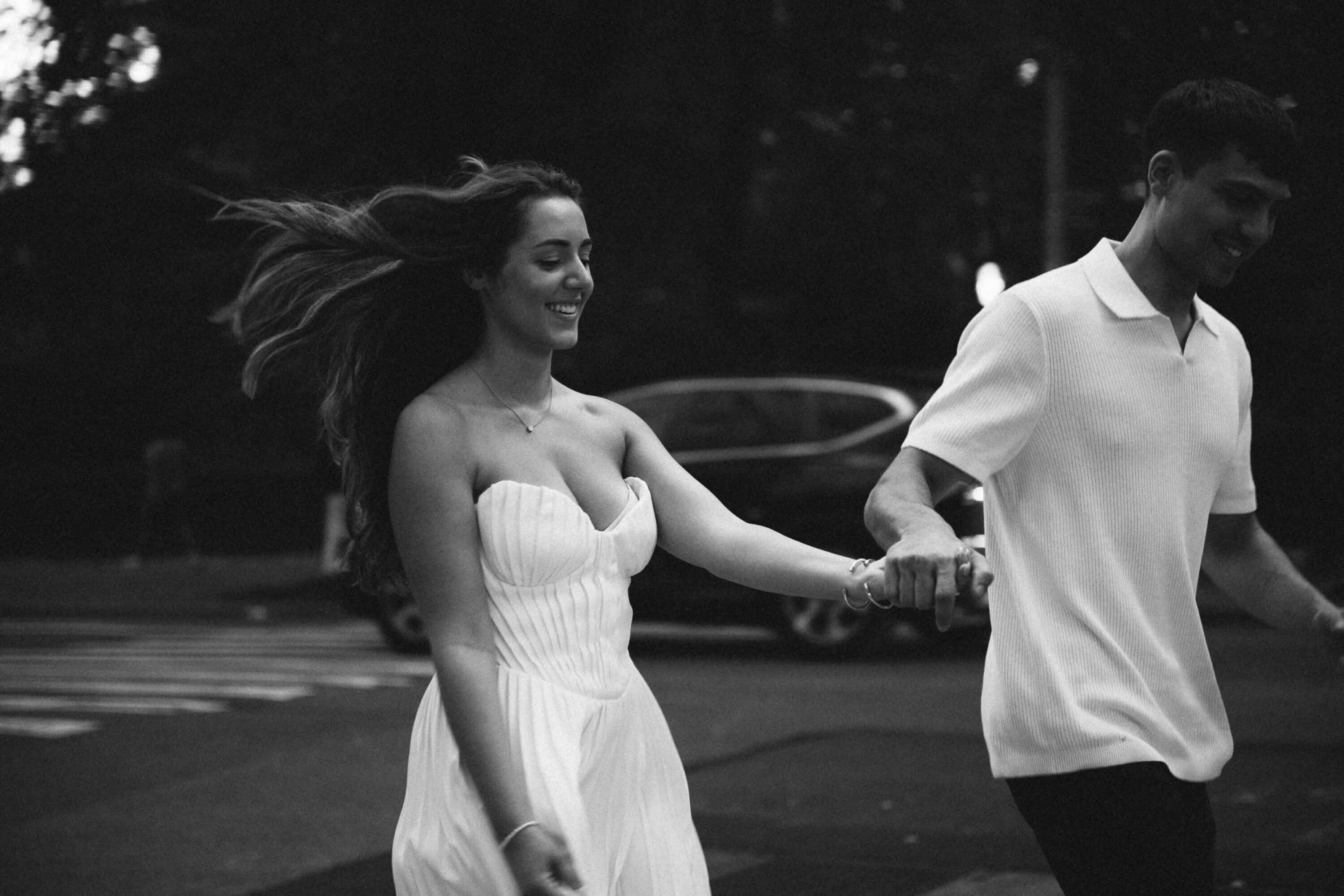 Candid Central Park engagement photos of a couple walking through the park