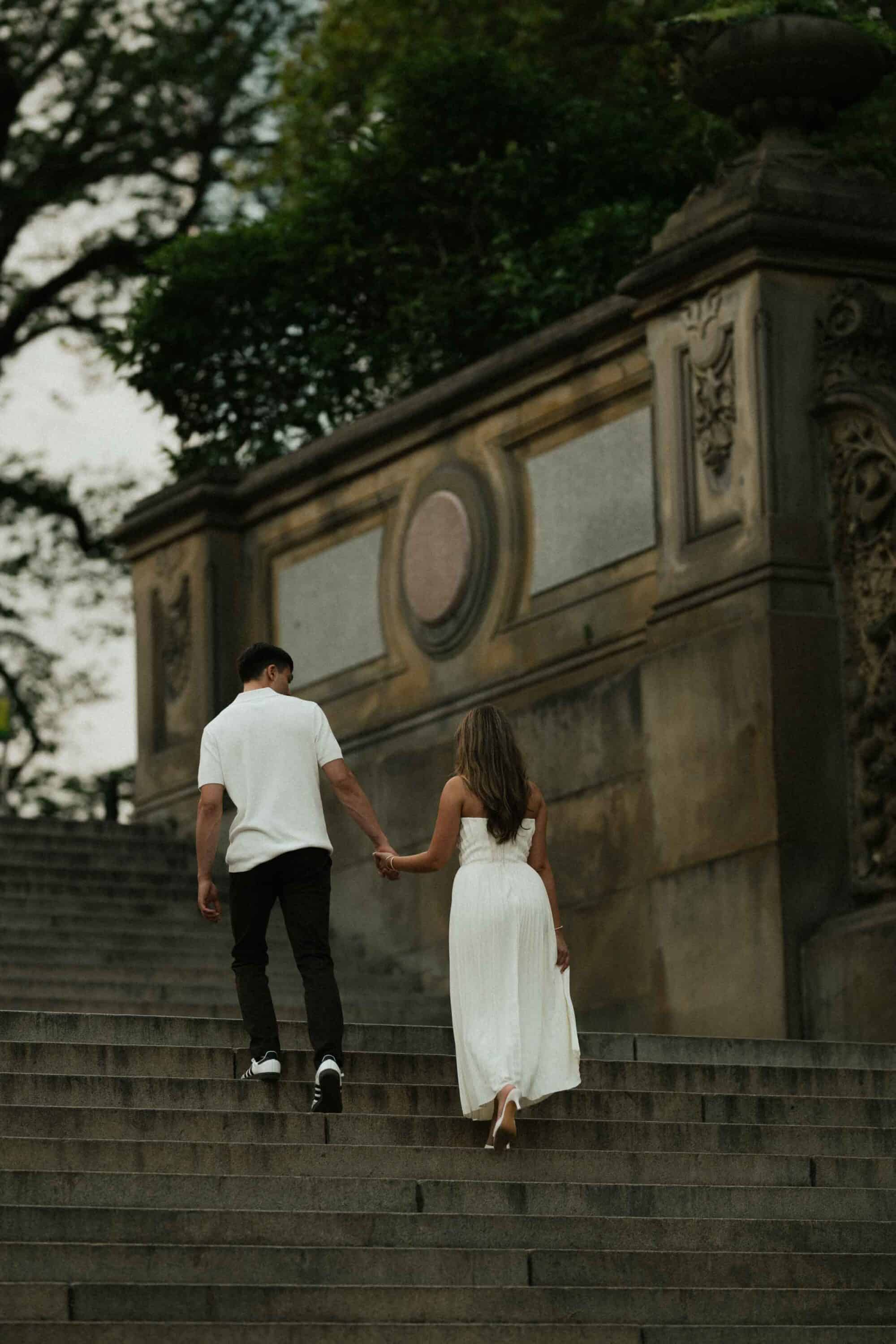 Candid Central Park engagement photos of a couple walking through the park