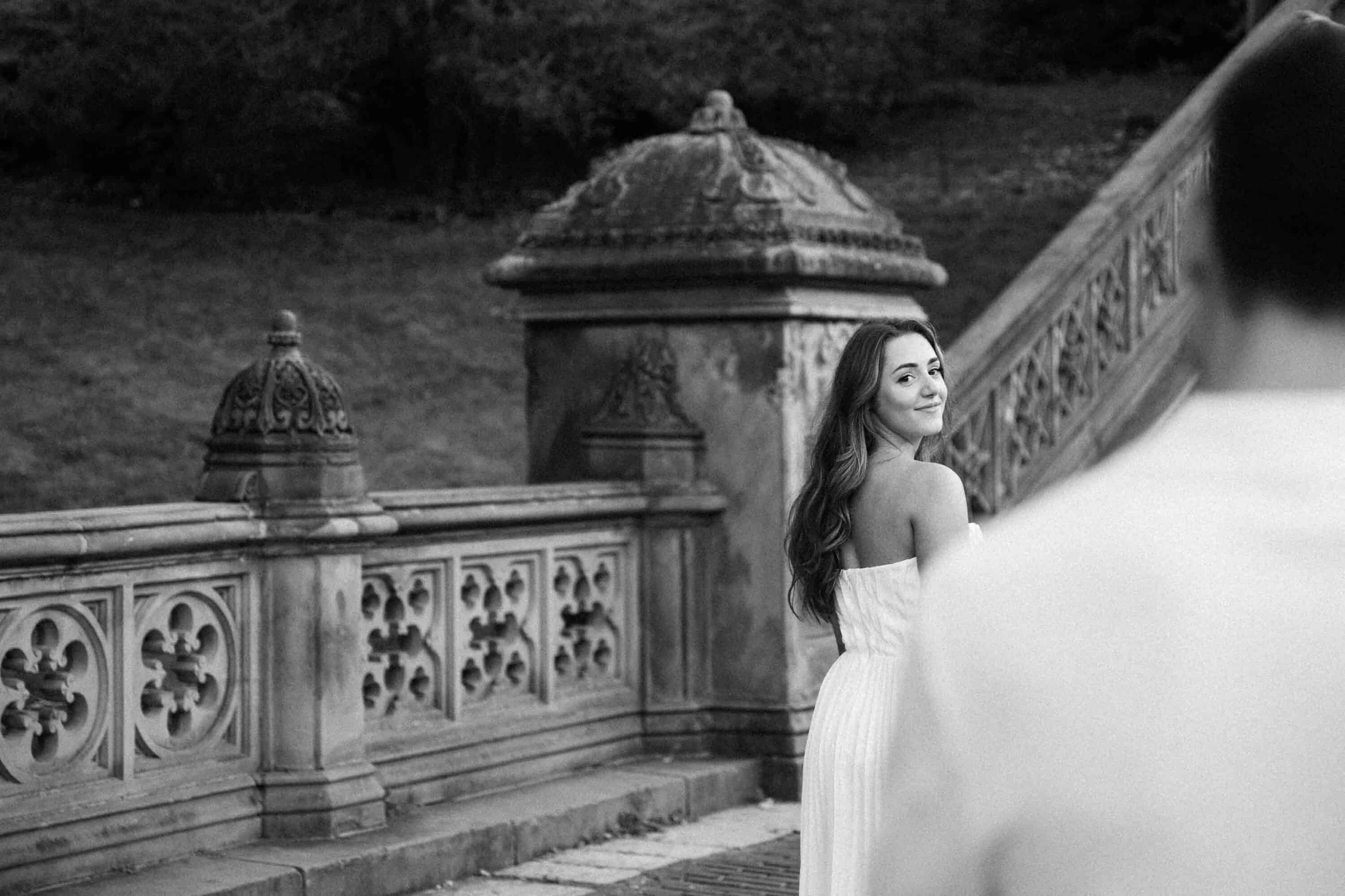 Candid Central Park engagement photos of a couple walking through the park